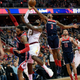 Cleveland Cavaliers forward LeBron James (23) goes to the basket against Washington Wizards guard Bradley Beal (3), forward Mike Scott, left, and Washington Wizards center Marcin Gortat (13), of Poland, during the first half of an NBA basketball game, Sunday, Dec. 17, 2017, in Washington. (AP Photo/Nick Wass)